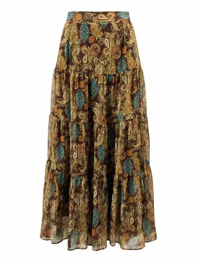 Falda larga con estampado floral en tonos marrón, verde azulado y dorado, con una silueta fluida y plisada.