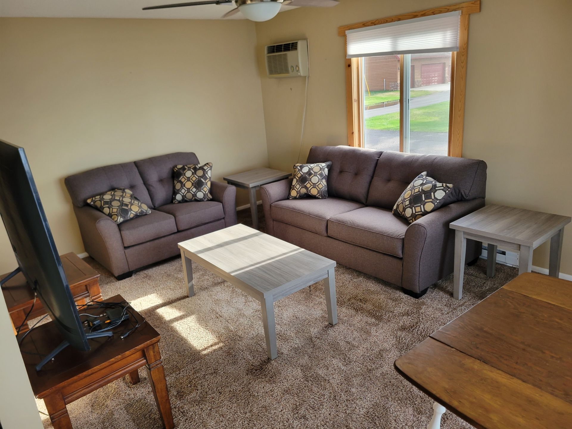 A living room with a couch , table , and television