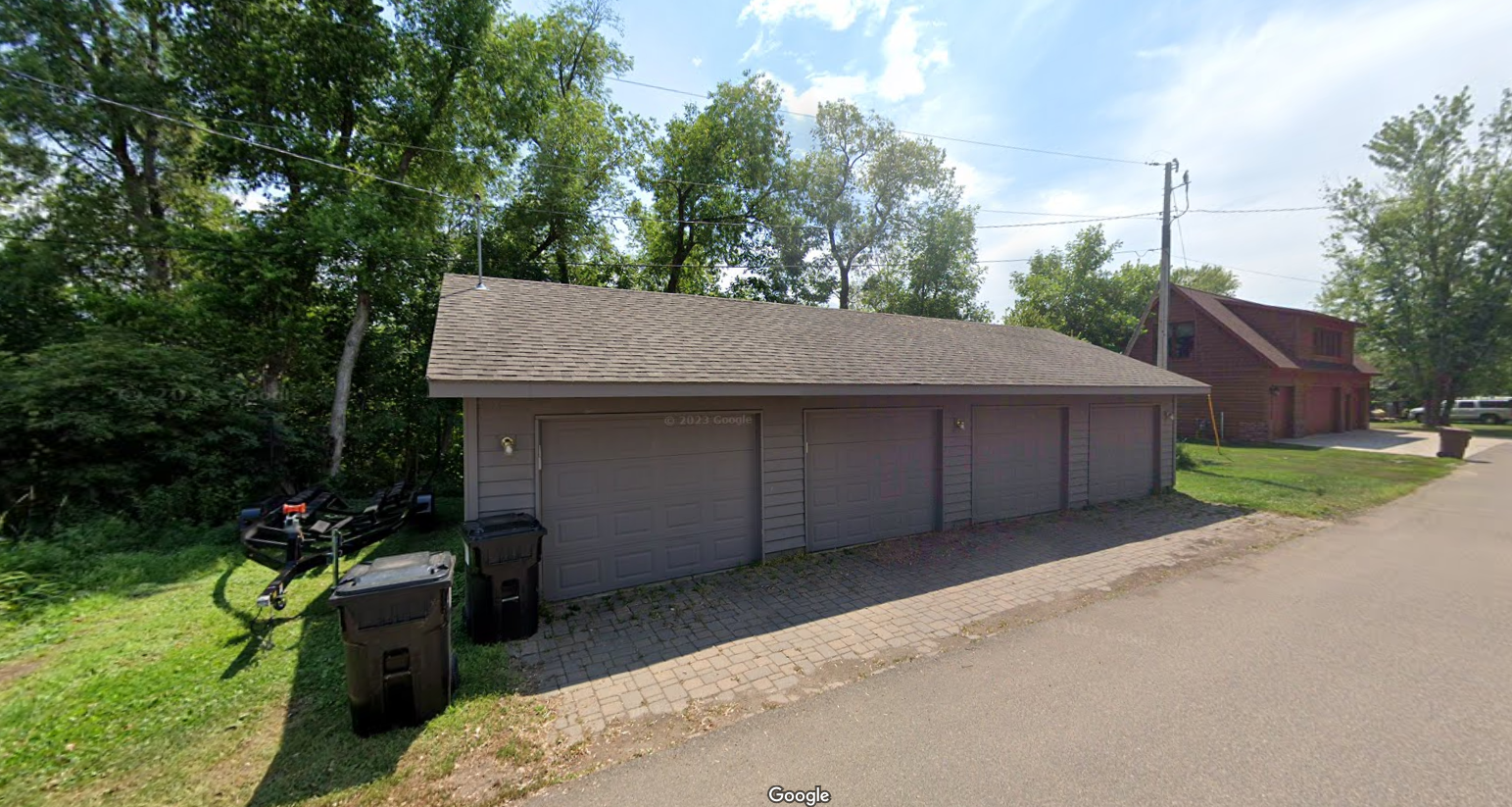 A garage with a bicycle parked in front of it.