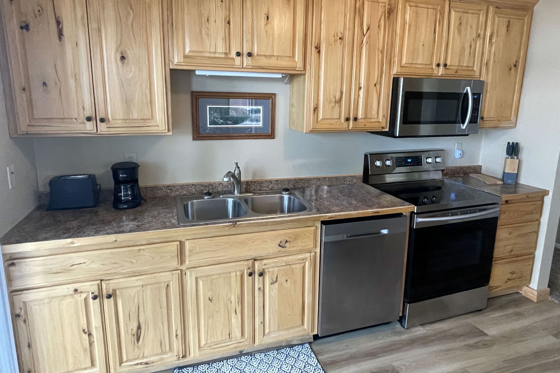 A kitchen with wooden cabinets and stainless steel appliances