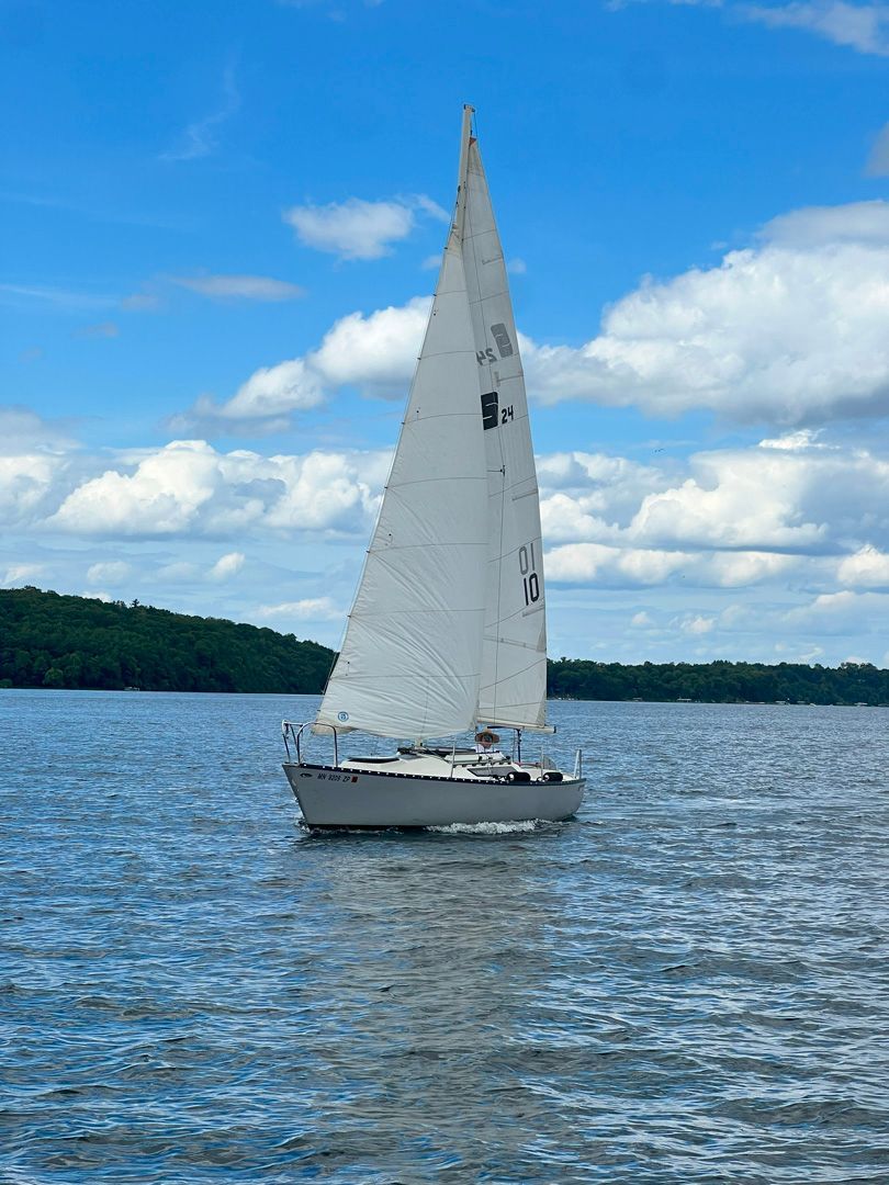 A sailboat is floating on top of a large body of water.