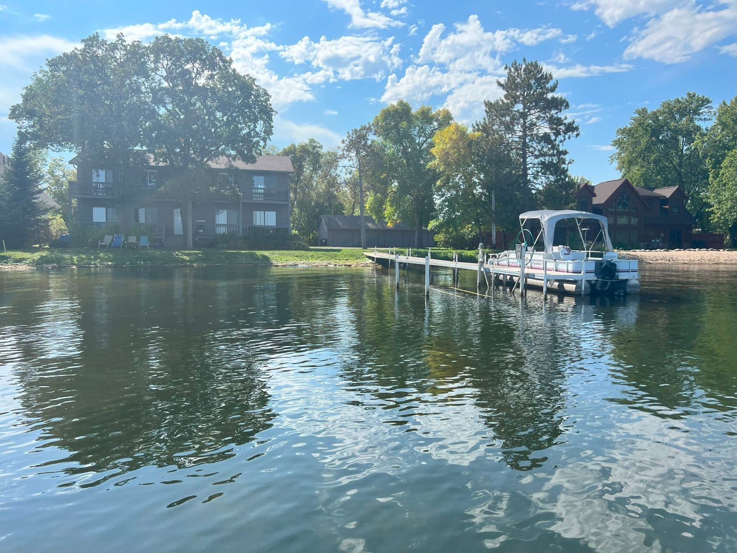 A boat is docked at a dock on a lake