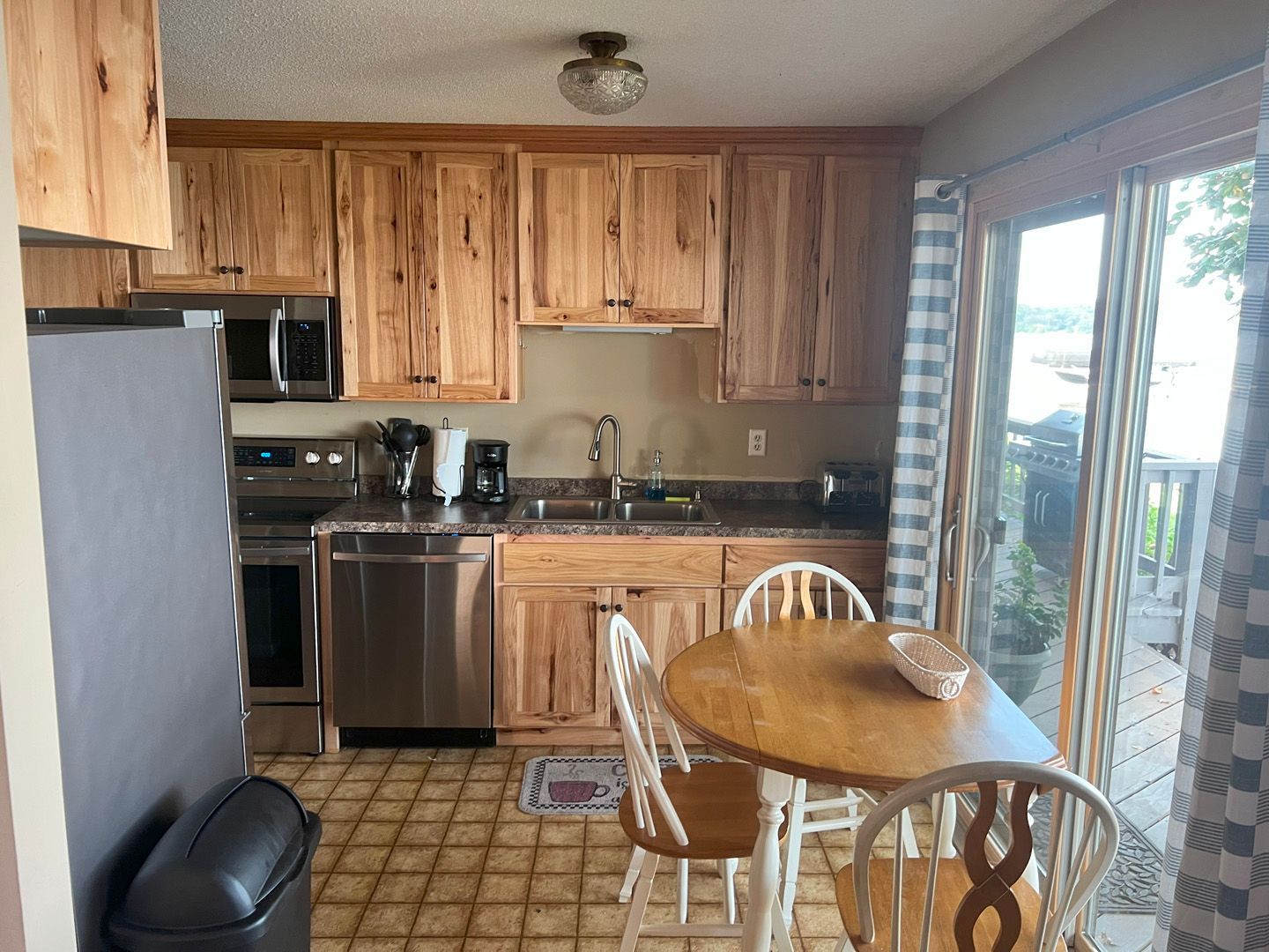 A kitchen with wooden cabinets and stainless steel appliances