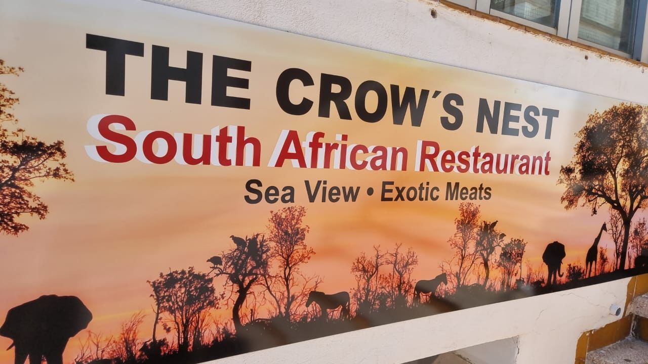 A sign for the crow 's nest south african restaurant