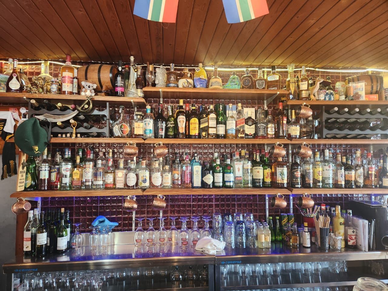 A bar filled with lots of bottles and glasses