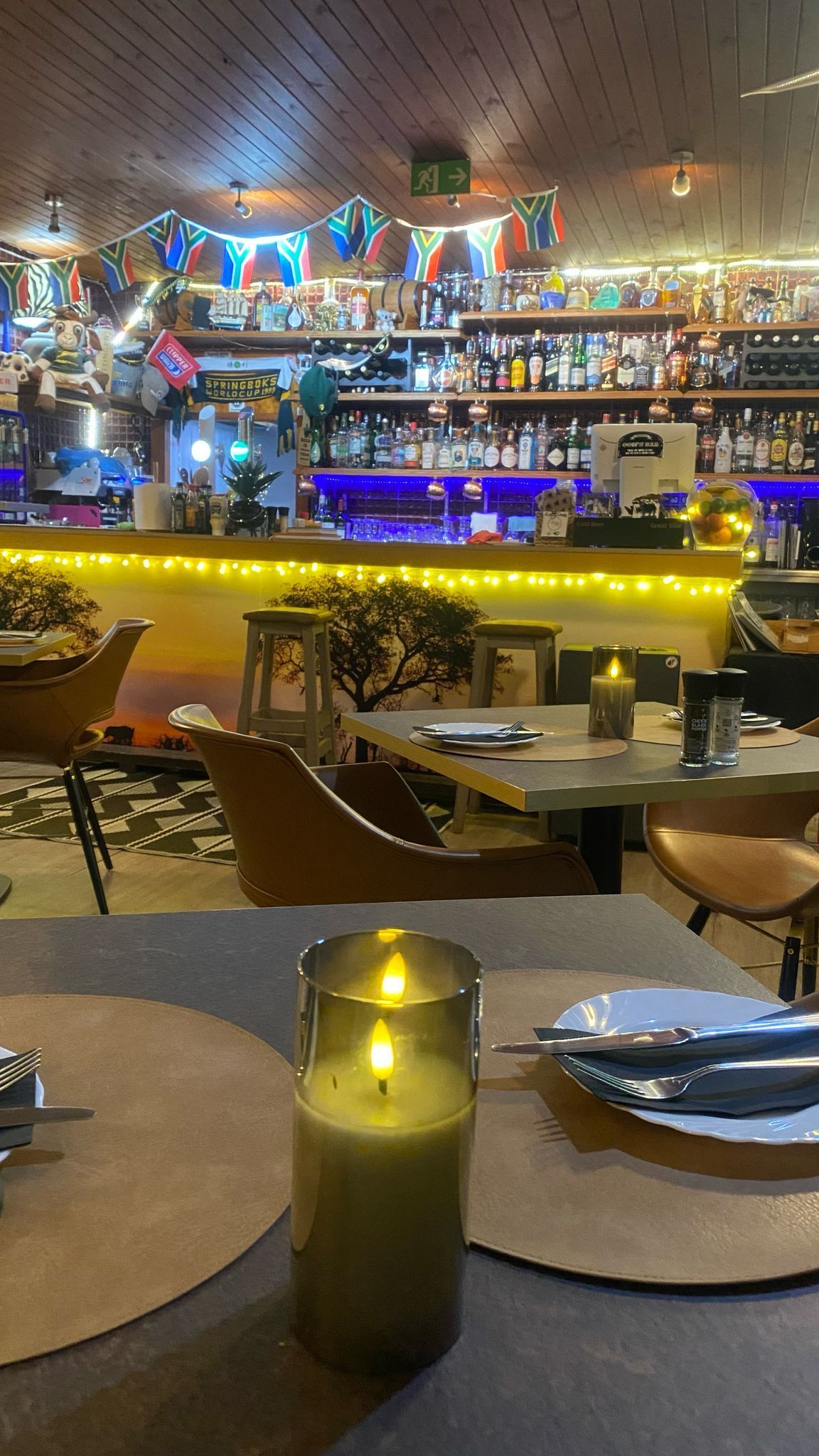 A candle is sitting on a table in a restaurant.