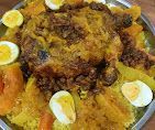 طبق كبير من الأرز الأصفر يعلوه دجاج مقلي وشرائح بيض مسلوق