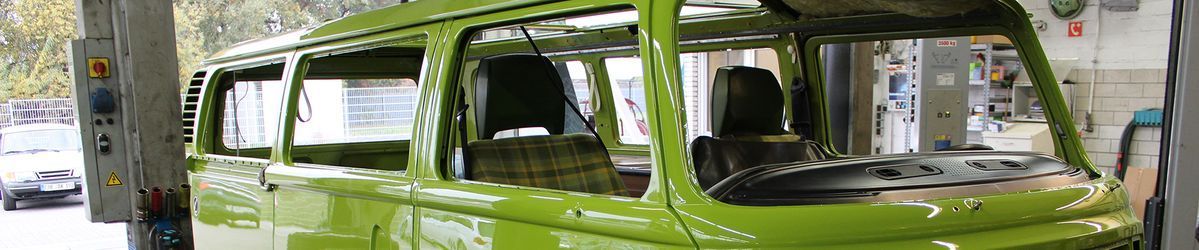 Ein grüner Bus steht in einer Garage.