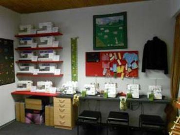 Raum voller Nähmaschinen auf Tischen und Regalen