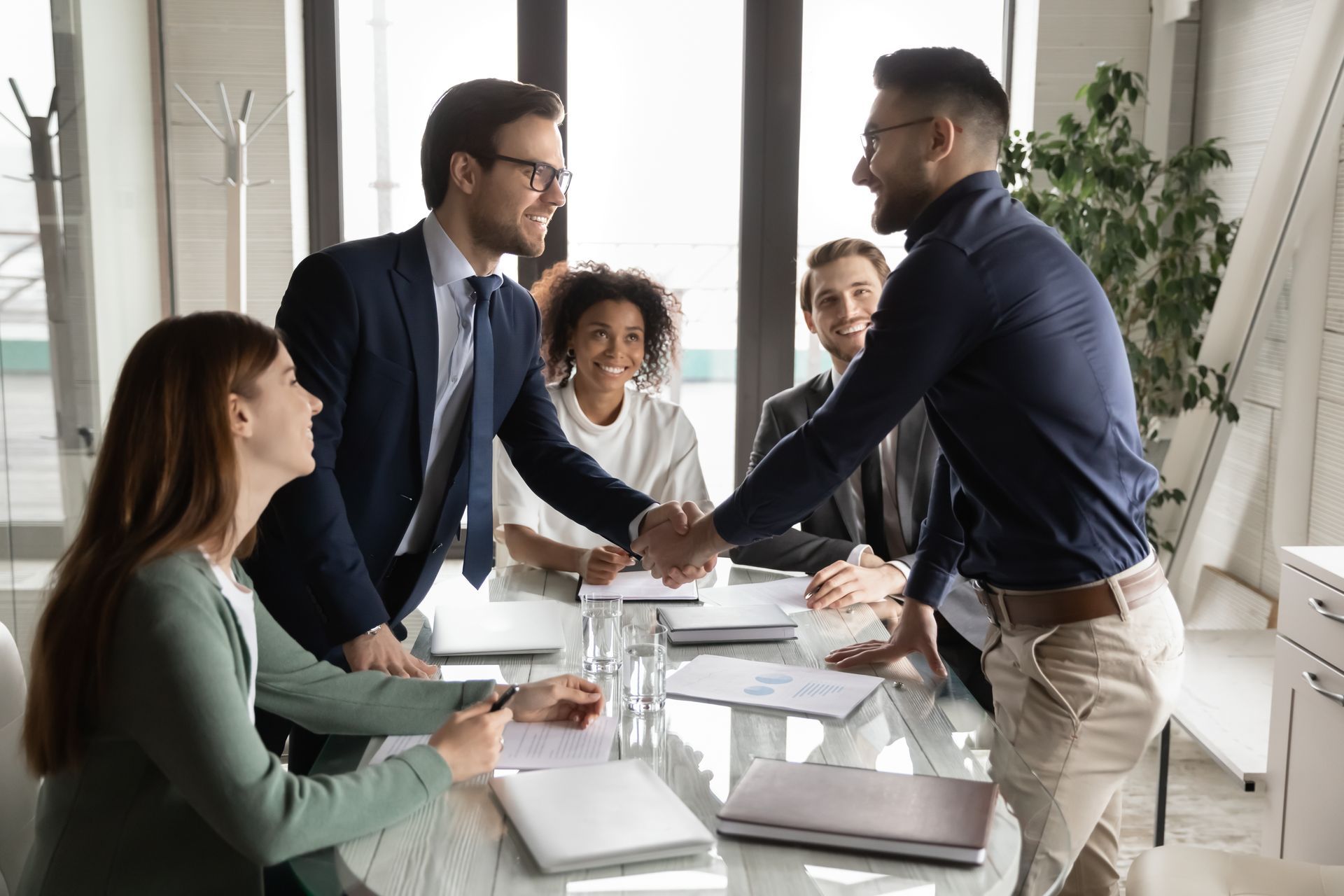 two people shaking hands in an office