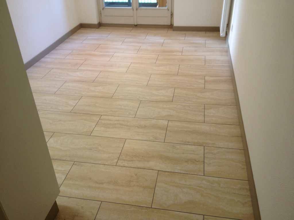 Ein Raum mit gefliestem Boden und einem Fenster