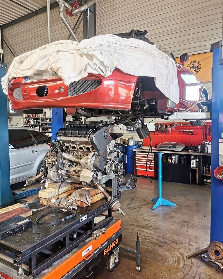 Atelier automobile avec pièces détachées rouges suspendues et établi de travail