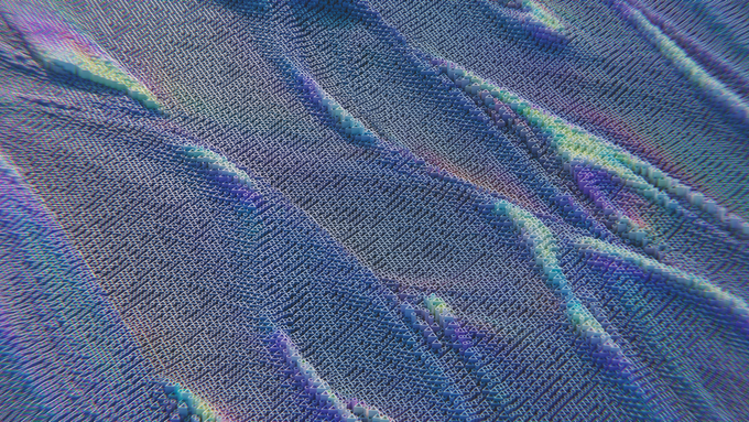 Un primer plano de una tela azul con una textura de color arcoíris.