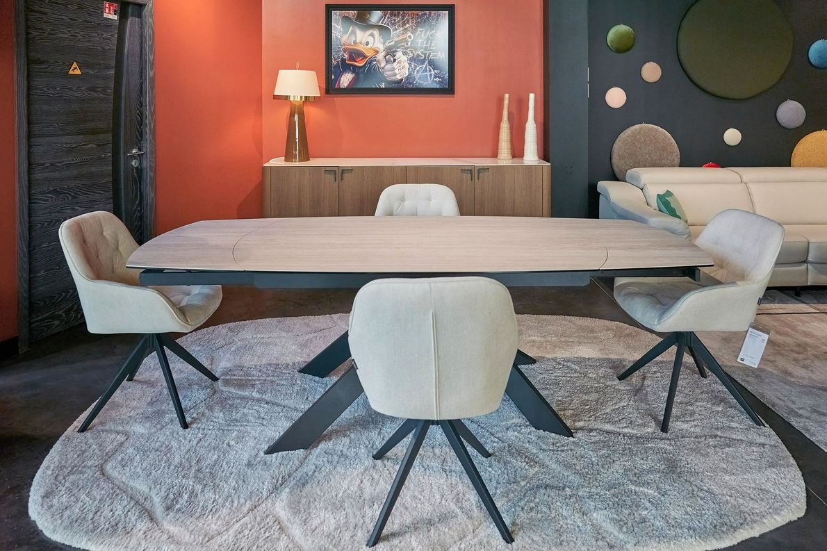 Une table avec quatre chaises et un tableau de canard