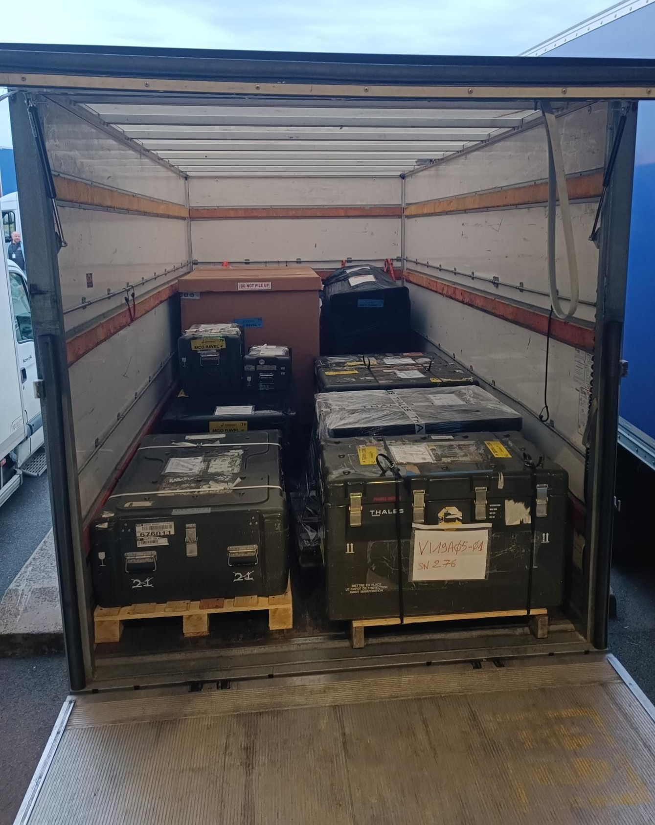 Des cartons et du matériel chargés dans un camion, prêts pour le transport.