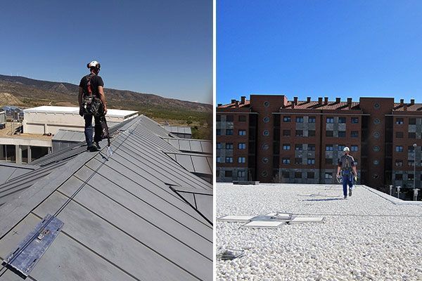 Un hombre está parado en lo alto de un tejado al lado de un edificio.