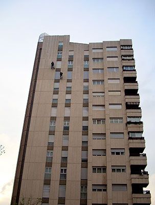 Un edificio alto con muchas ventanas y balcones.