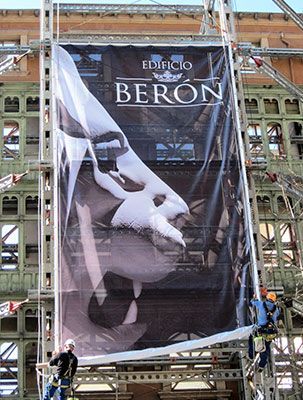 Se está instalando una gran valla publicitaria en el lateral de un edificio.