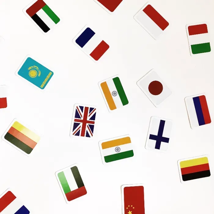 A bunch of flags are scattered on a white surface.