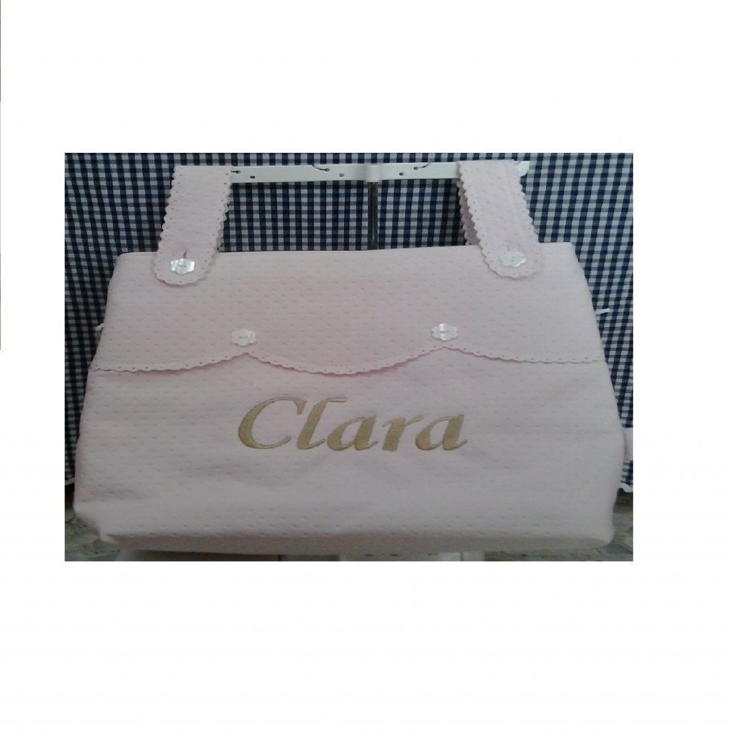Bolso rosa claro con asas blancas y la inscripción 