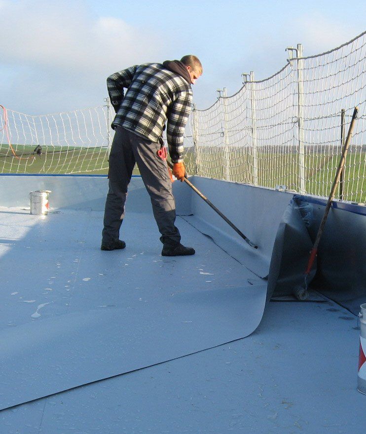 Personnel refaisant l'isolation du toiture plate