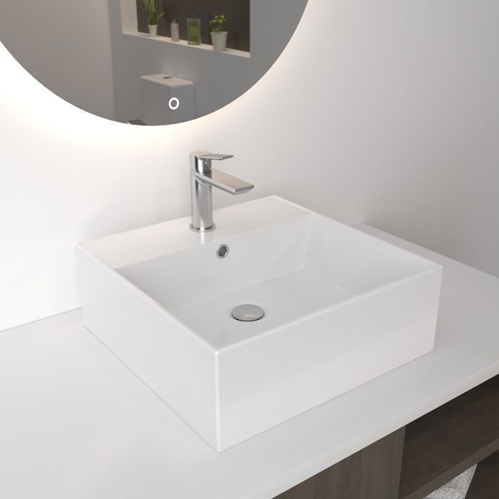 Un lavabo de baño con un espejo redondo encima.
