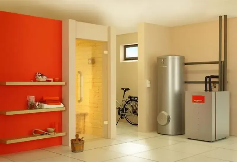 Baño moderno con pared naranja, ducha, estantes, calentador de agua y bicicleta.
