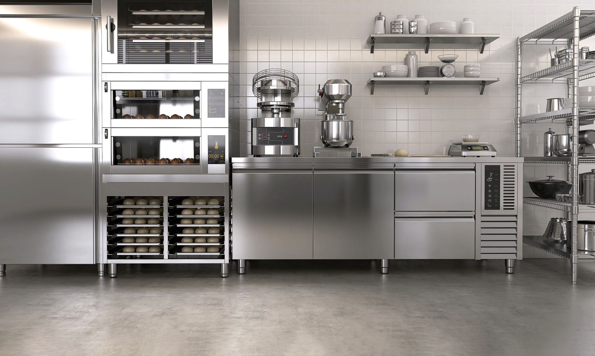 Cuisine commerciale moderne en acier inoxydable avec fours, mélangeurs, étagères et comptoirs de préparation.