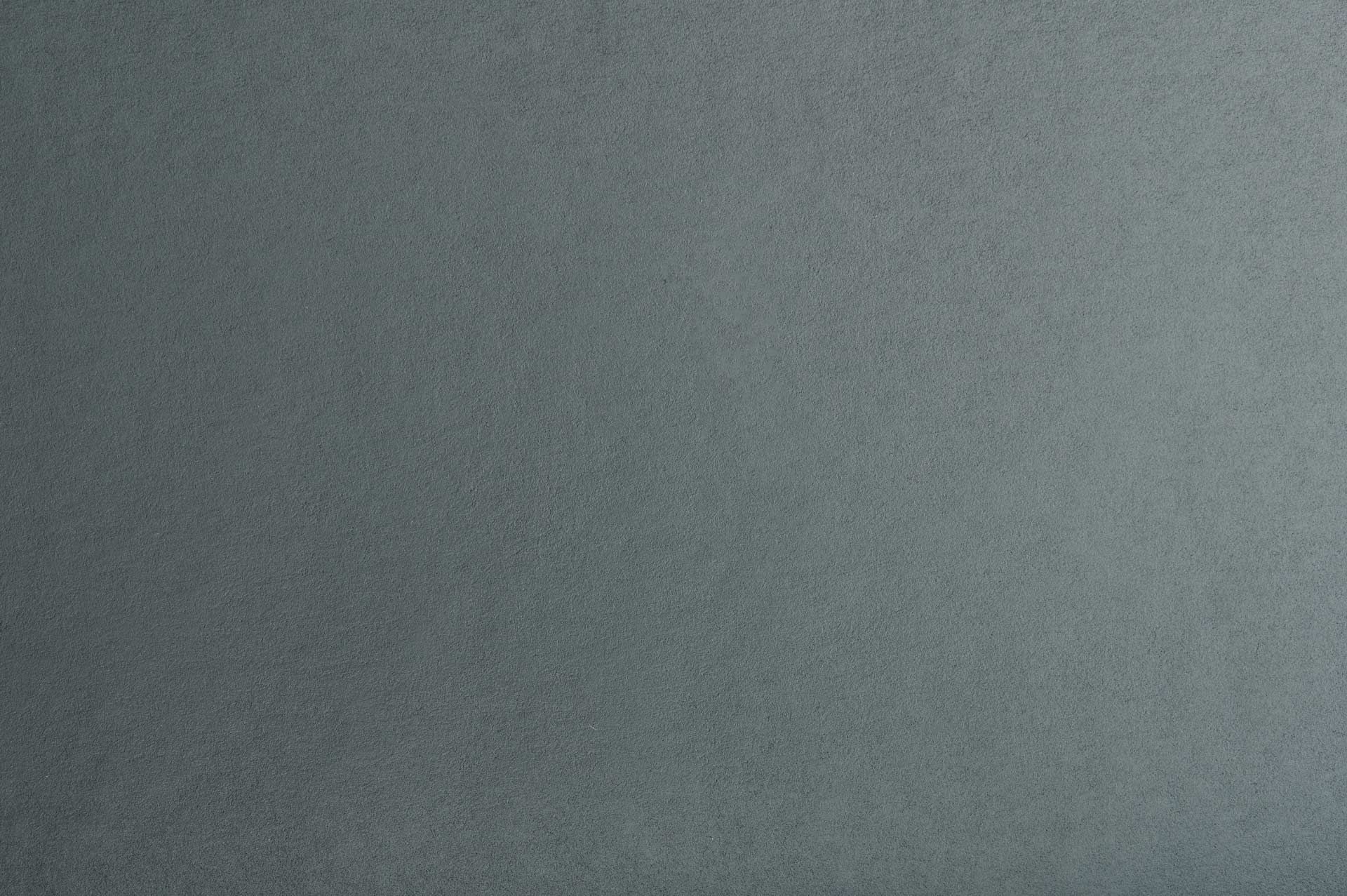 Une surface solide, gris ardoise, avec une texture subtile et finement granuleuse.