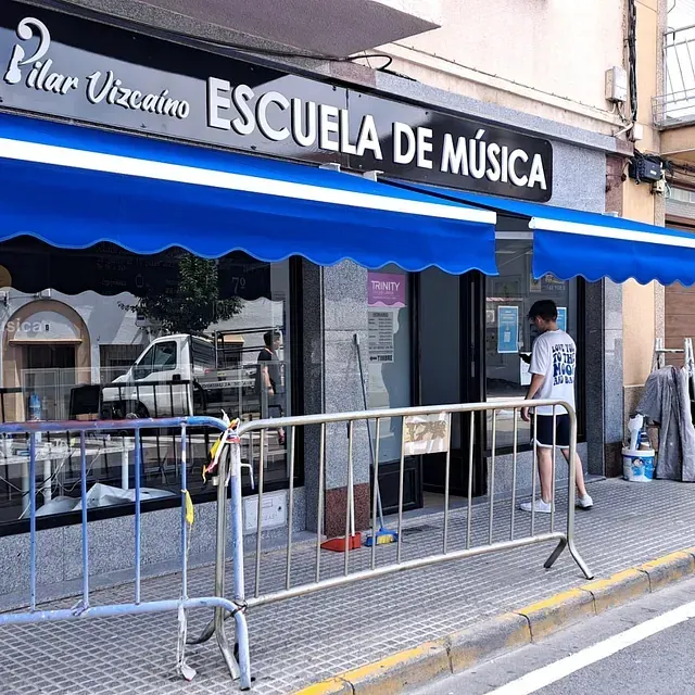 Pilar vizcaino escuela de musica store front with blue awning