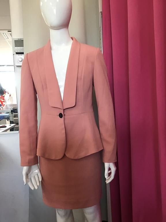 ailleur féminin saumon avec veste ajustée et jupe droite.