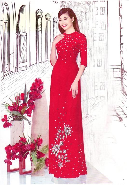 Robe traditionnelle rouge élégante ornée de broderies délicates, mise en avant dans un atelier avec des détails artistiques.