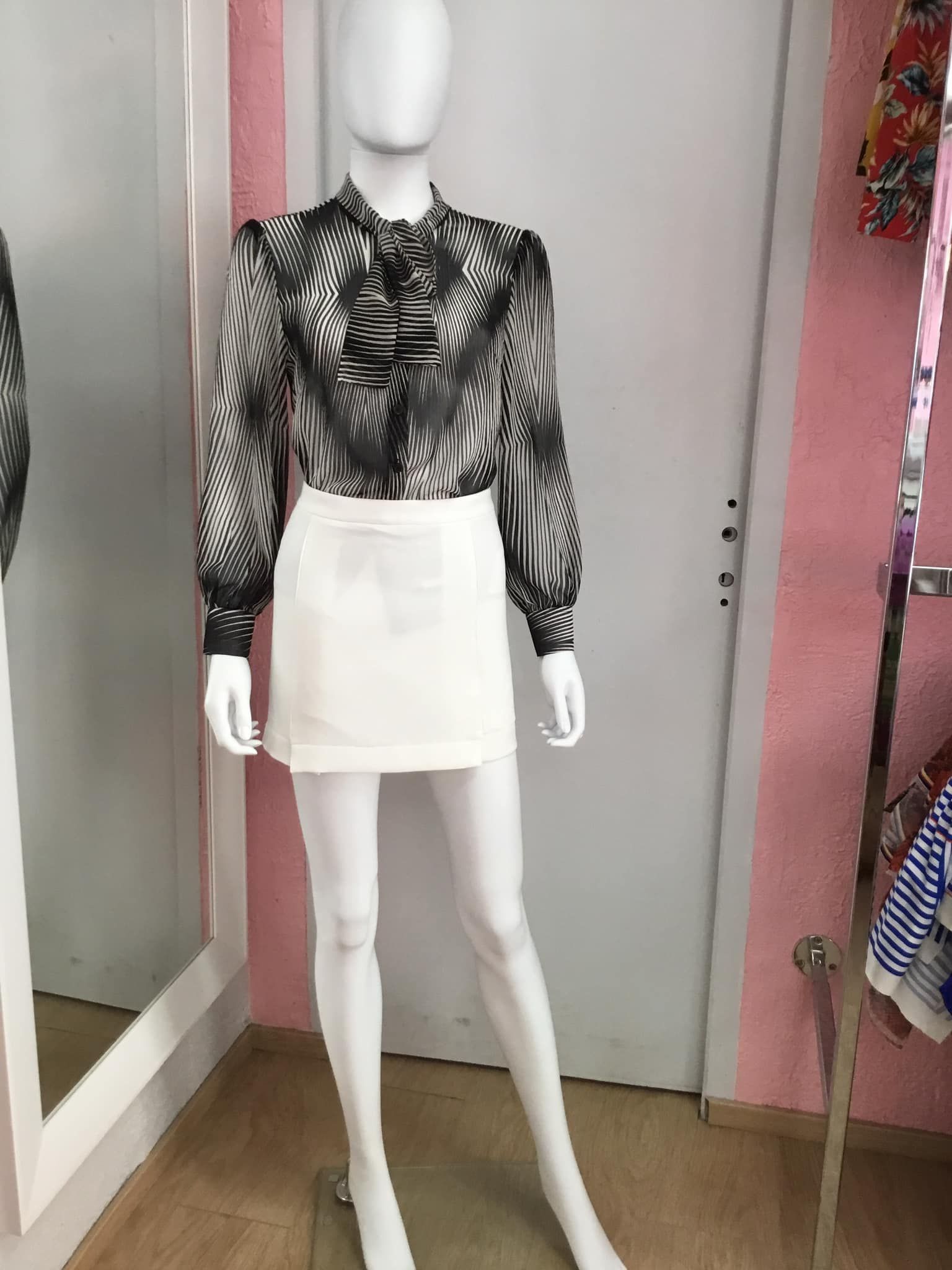 Ensemble noir et blanc avec blouse à motifs floraux et jupe blanche