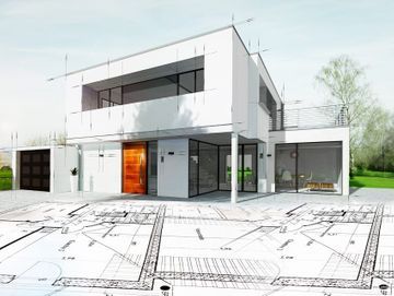 Modell eines Hauses auf einem Bauplan