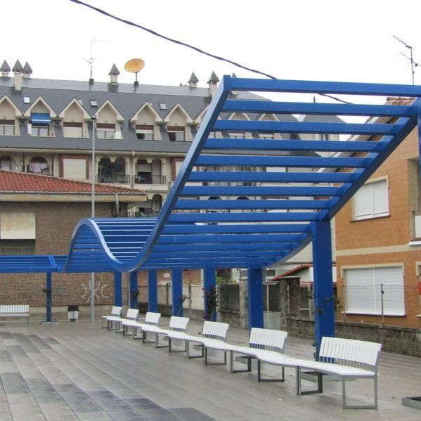 Una fila de bancos blancos bajo un dosel azul