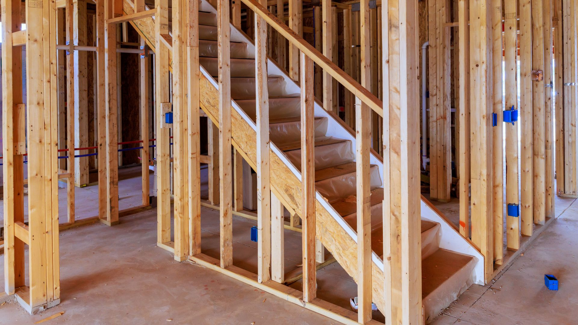 Maison à ossature en bois intérieure avec escalier en bois en construction.