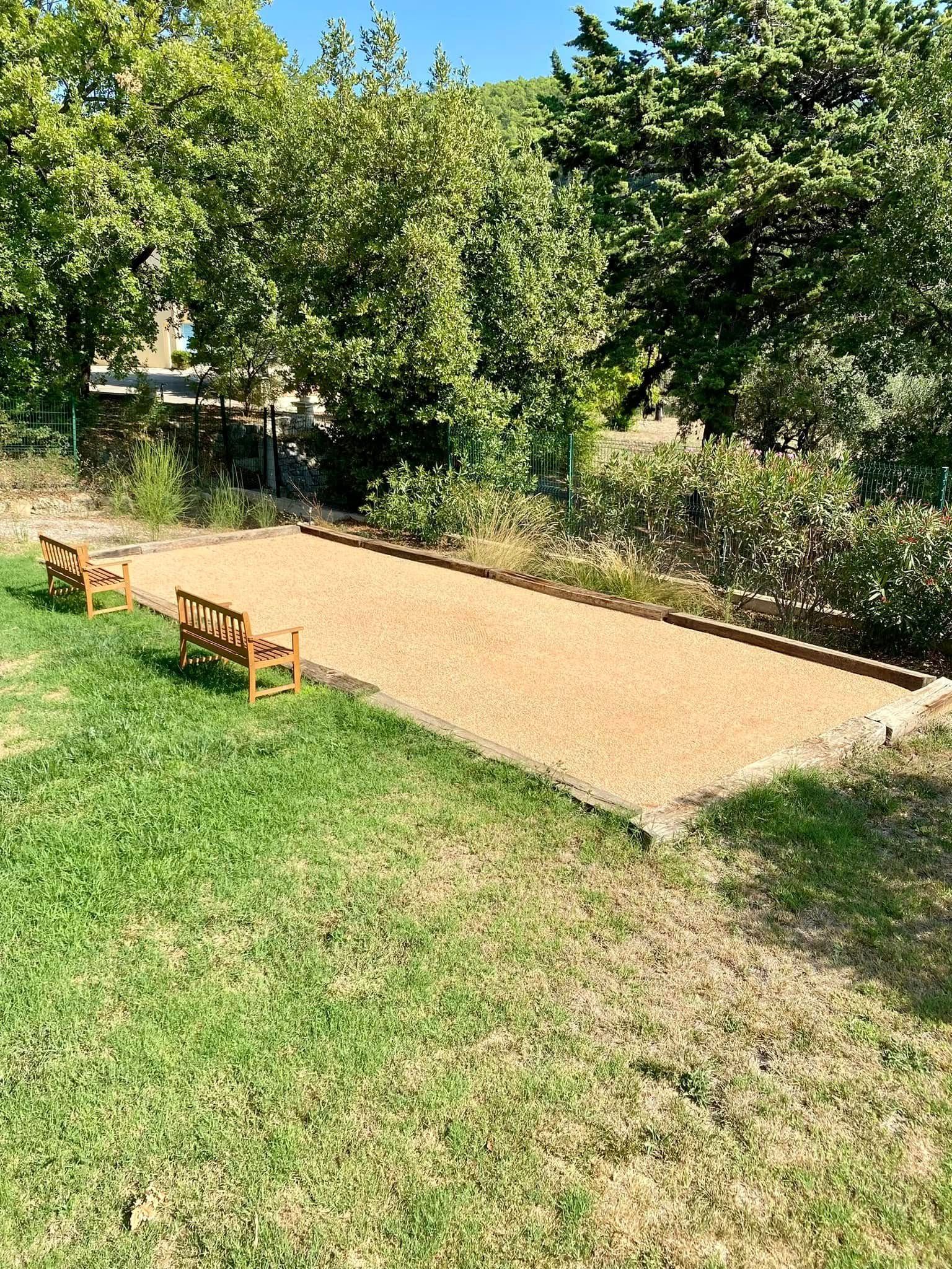 Deux bancs au bord d'un terrain de pétanque