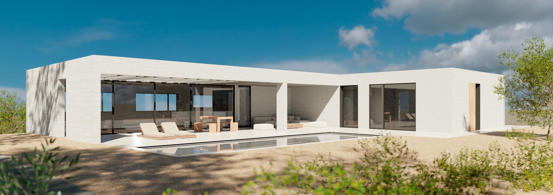 Moderna casa blanca de diseño abierto, con amplios ventanales y patio. Ubicada en un paisaje natural con arbustos y un cielo azul despejado.