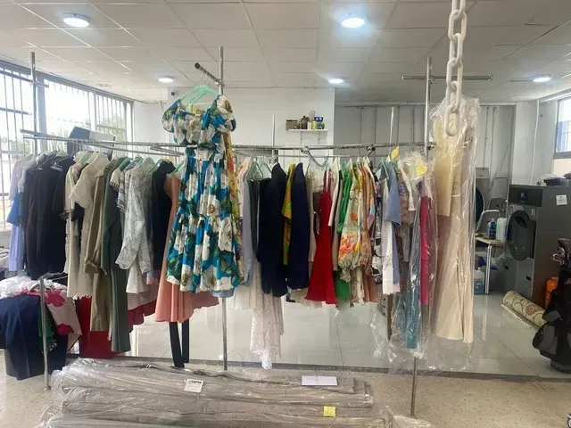 Perchero con ropa en tintorería. Vestidos, trajes y otras prendas.