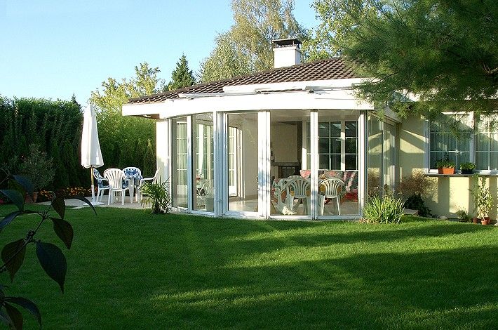 grüne Wiese und weißer Wintergarten