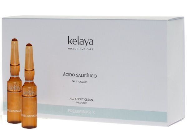 Un exfoliante facial físico de la marca Kelaya en un frasco blanco y su caja de cartón a juego sobre un fondo blanco.