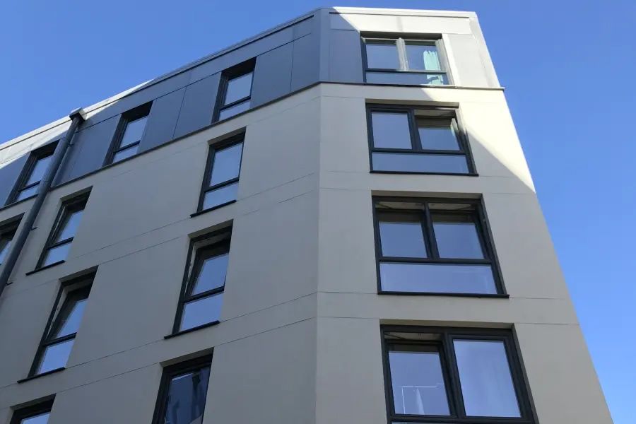 A building with a lot of windows and a blue sky in the background