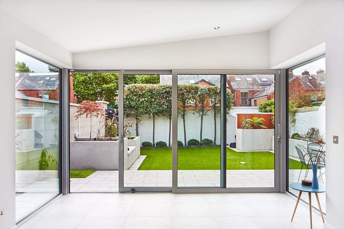 A living room with sliding glass doors leading to a backyard.