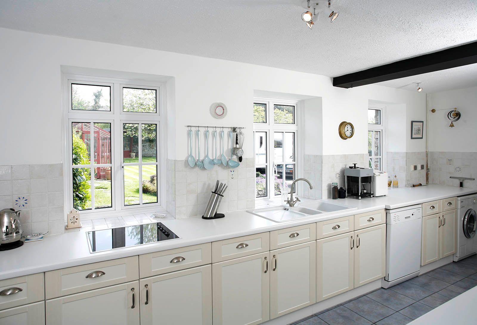 A kitchen with white cabinets and a stove top oven
