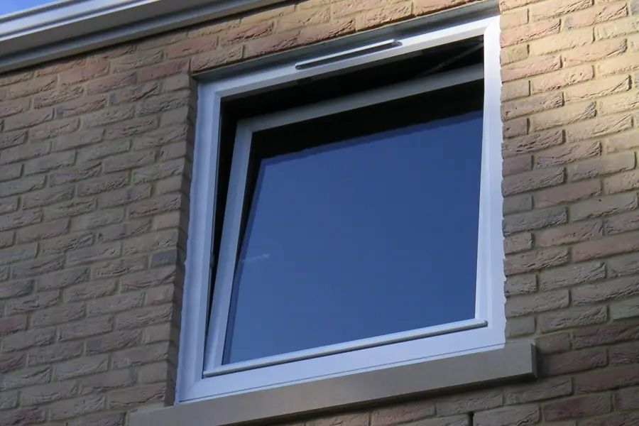 A brick building with a window that is open