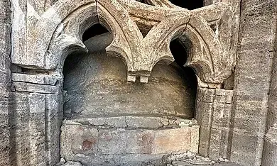 Un primer plano de una piedra tallada en el costado de un edificio.