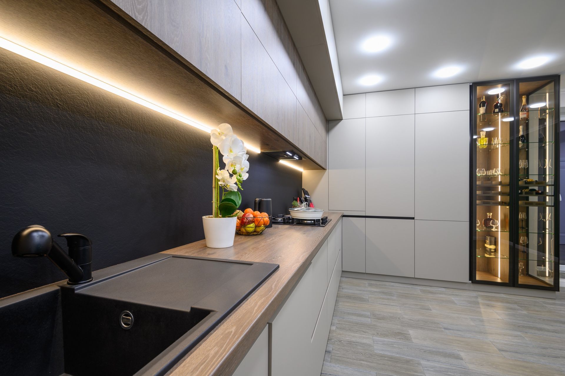 Una cocina con fregadero, estufa y gabinetes.