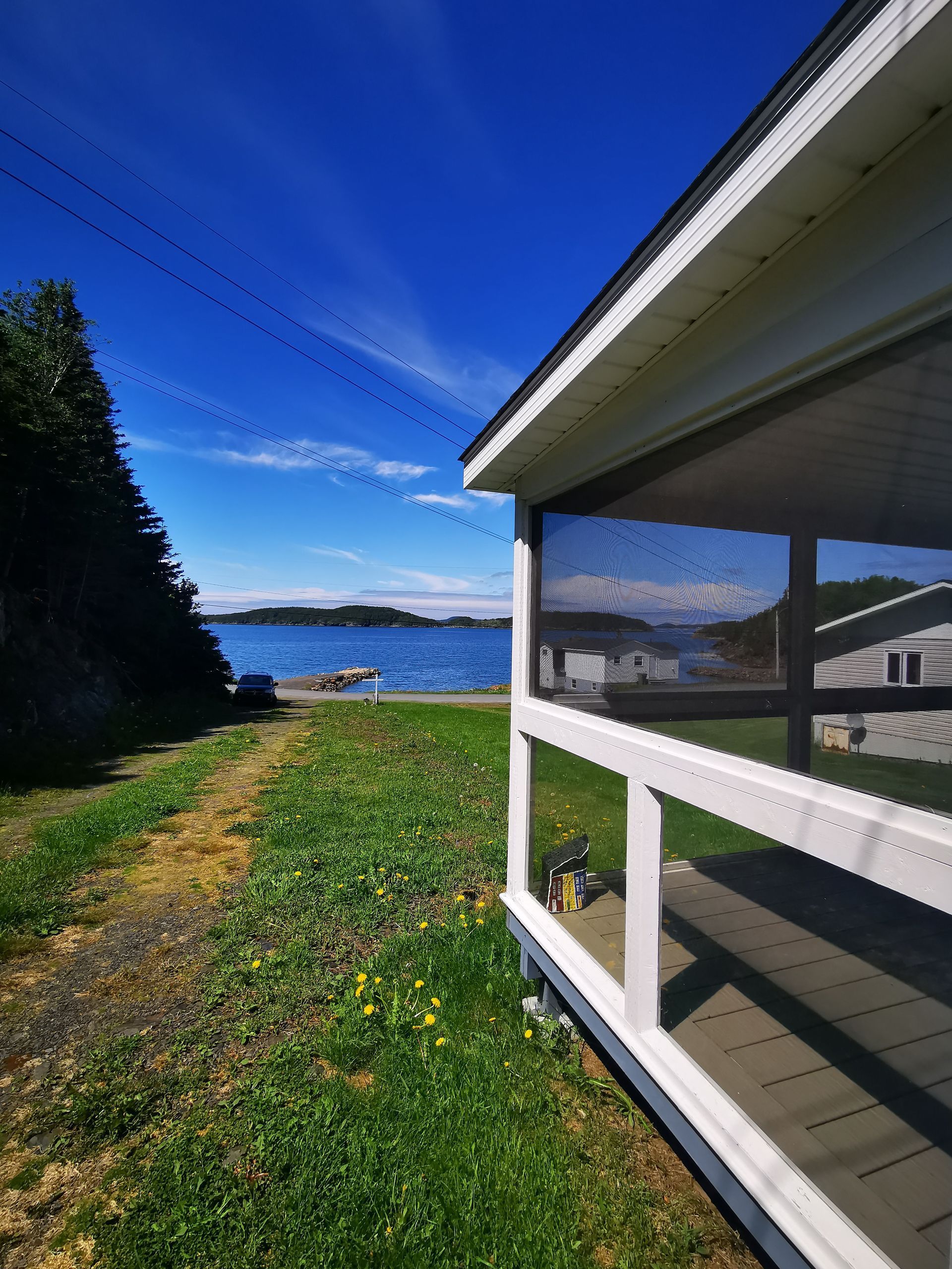 A screened in porch with a view of a body of water
