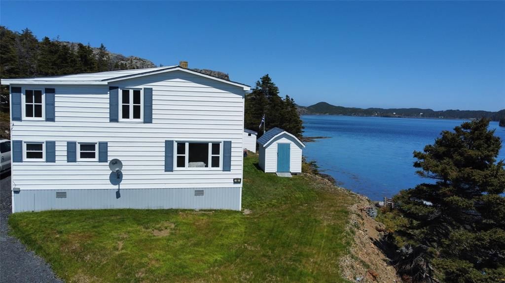 A white house with a wooden fence in front of it