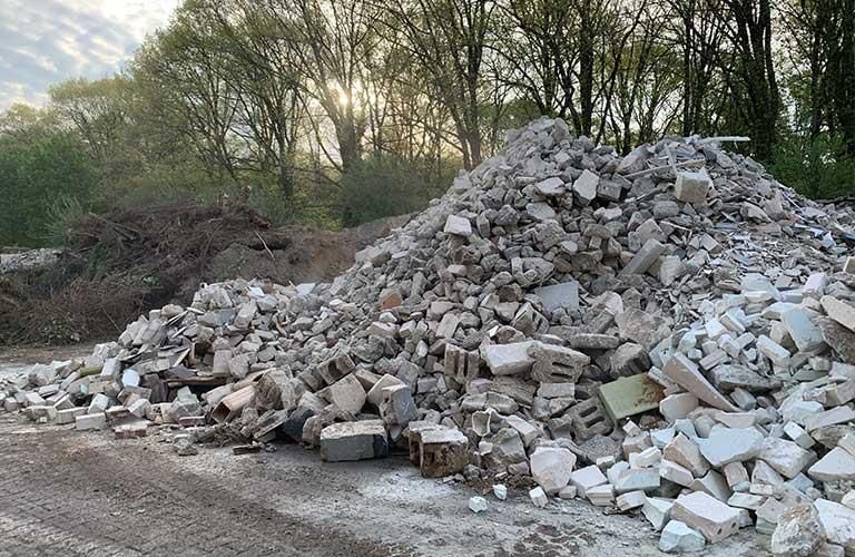 Am Straßenrand liegt ein Stapel Ziegelsteine.
